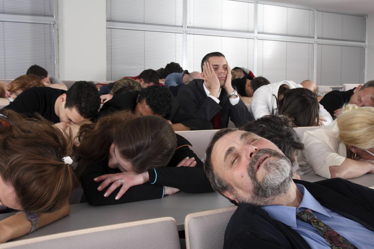 students and their teacher asleep at their desks